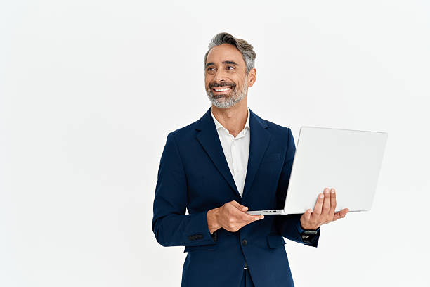 istock Happy mature business man using laptop standing isolated on white background. 2256328662