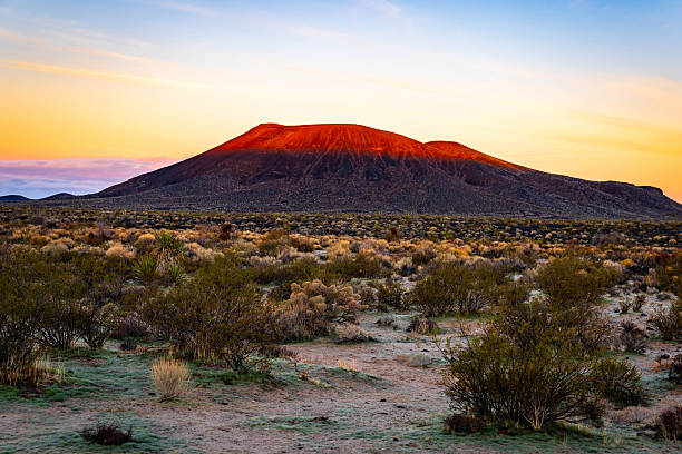 Sunset light covers cinder cone volcanoes and valley in the Mojave Desert California