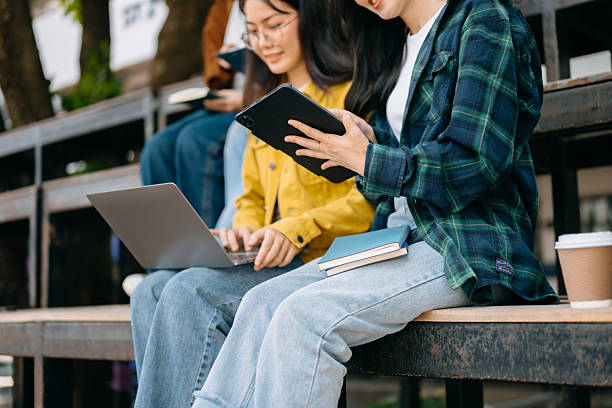 istock Young Asian People college students and a female student group work at the campus park 2256354910