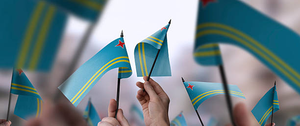 Aruba flags in their hands on a blurred urban background. The photo illustration was created without the use of artificial intelligence, only using Photoshop.