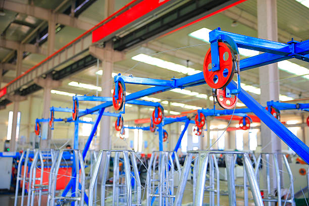 The red wheels rotating on the mechanical equipment are located in the wire mesh factory