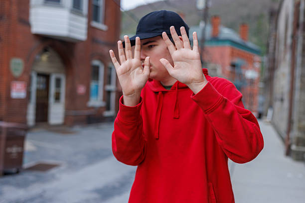 Serious young man wearing a toque hat looking at the camera at a coffee shop