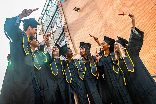 istock Diverse graduates celebrating achievement holding diplomas at university 2256375093