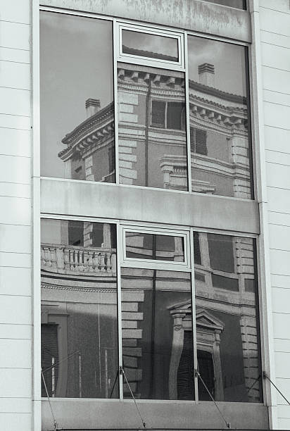 Black and White Architectural Reflection of Classical Building in Modern Glass Office Facade