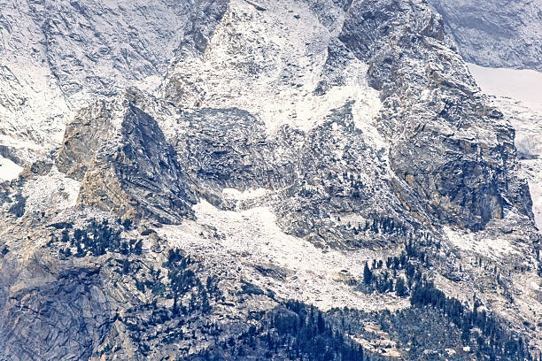 Rock face on a mountain with new fresh snow