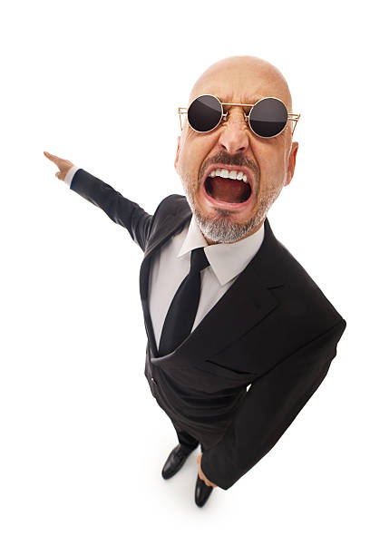 Full length profile shot of a young movie director holding a clapperboard and shouting on a megaphone isolated on white background