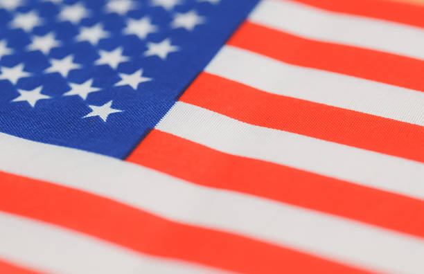Textured American flag close-up emphasizing patriotism, identity, and national symbolism.