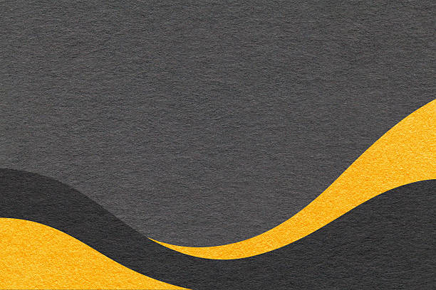 Textured black paper background with yellow wavy lines and waves, copy space for banner, presentation.