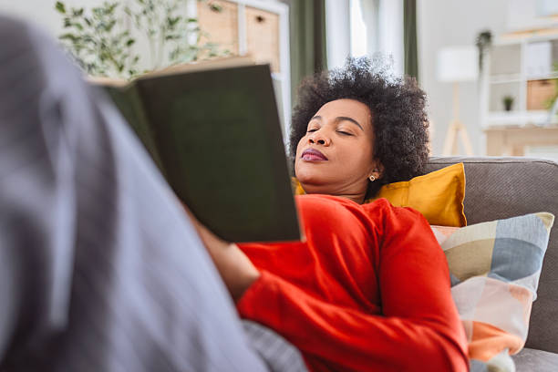 istock Smiling Person Relaxing with a Book 2256393258
