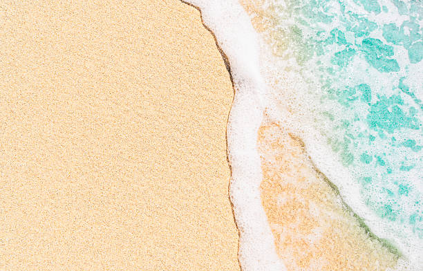 istock beautiful sunny sandy beach background, closeup, top view 2256397555