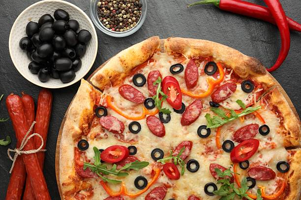 istock Tasty pizza and ingredients on black table, top view 2256405526