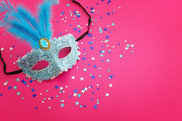 Holidays image of masquarade mask over pink background. view from above