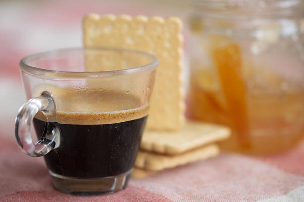 creamy espresso in glass cup orange juice and biscuits on pink pastel background healthy balanced breakfast concept and morning ritual