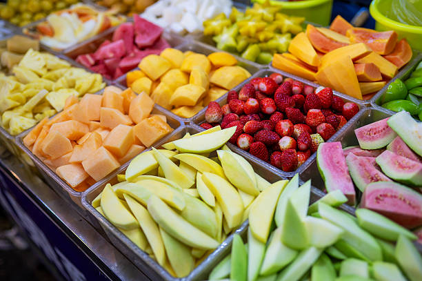 Assortment Of Colorful Sliced Fruits Displayed In Enticing Trays.