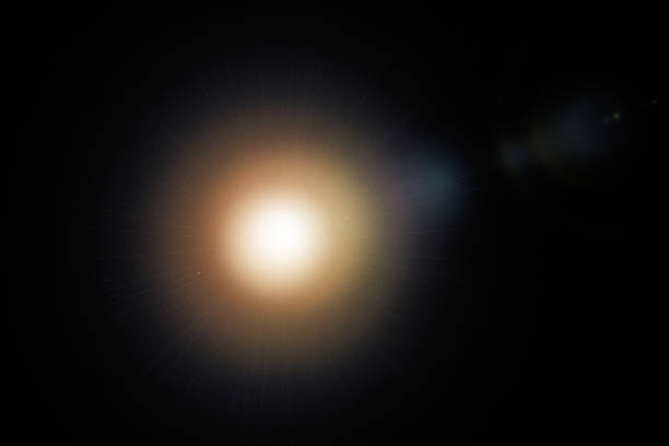 Abstract sun bursts, yellow glare on black background.light background.