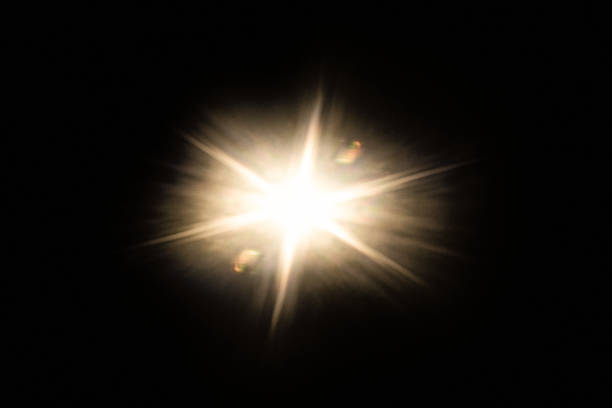Abstract sun bursts, yellow glare on black background.light background.