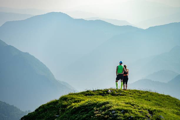 Hiking team people helping each other friend giving a helping hand while climbing up on the mountain rock adventure travel concept of friendship support trust teamwork success. High quality photo