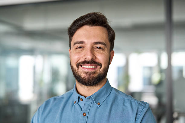 istock Happy professional Latin business man looking at camera at work, portrait. 2256421280