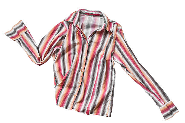Vibrant stacks of folded t-shirts in a wide array of colors are neatly arranged on a market stall, showcasing the variety and choice available to shoppers
