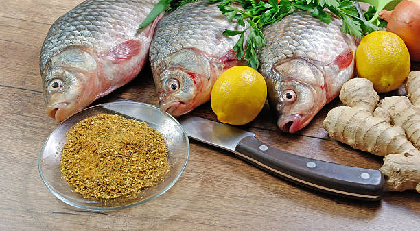 Fresh crucian on a wooden cutting board