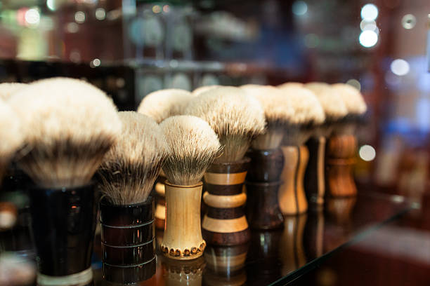 Close up color image depicting a selection of shaving brushes on display and for sale in the men's shaving store.