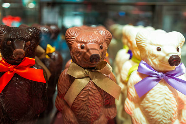 Close up of three chocolate bears - one dark, one milk and one white chocolate - for sale in the candy store.