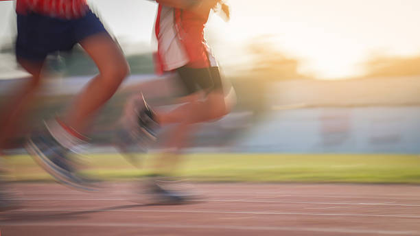 Young children having athletic exercise class running on the track, healthy lifestyle and children sport education concepts, finish line winner celebration, victory and success