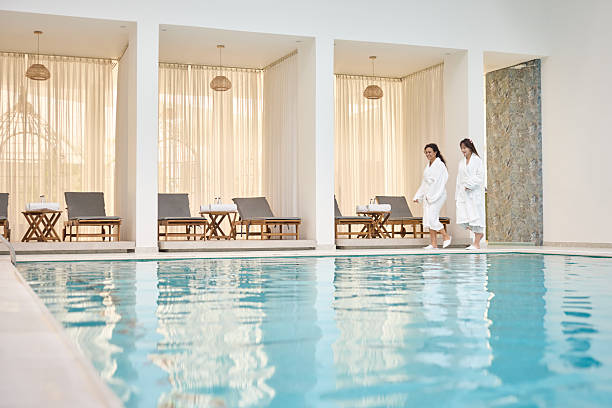 Two female friends spend a relaxing time at the luxury hotel's indoor pool