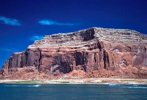Lake Powell - Butte's large size contrasts with two boats - 1990. Scanned from Kodachrome 25 slide.