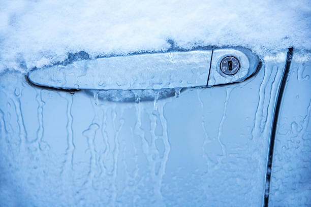Close up Car door lock covered in ice and snow on cold weather