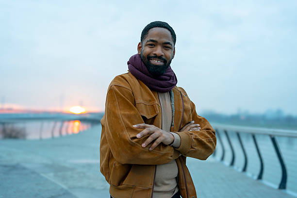istock Smiling man with arms crossed during urban sunset walk 2256453688