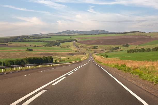 istock Asphalt country road among fields and picturesque nature 2256453998