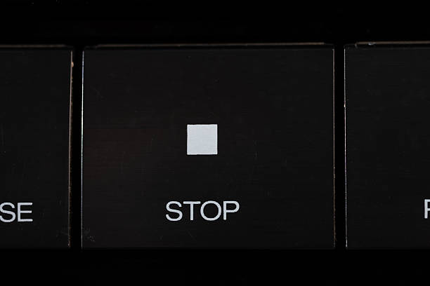 A close up of a black keyboard key labeled STOP, featuring a small white square symbol. This image conveys caution, pause, and control, ideal for safety, instruction, or tech themes.