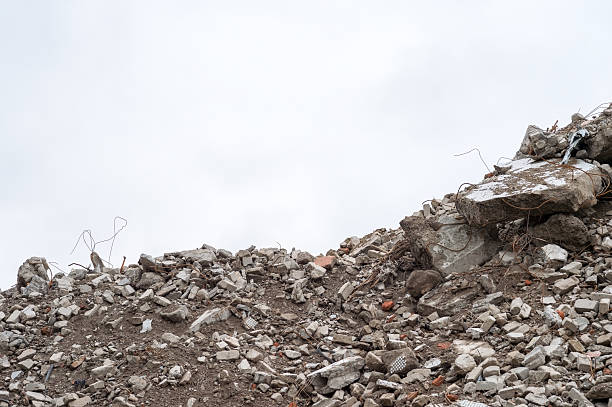 istock Debris and broken concrete rubble with exposed metal rods under cloudy sky, Copy space, destruction and decay concept 2256454755