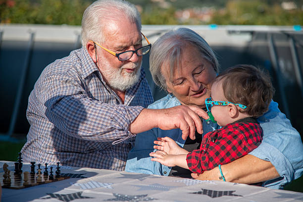 Grandparents and grandson playing outdoor on a spring day