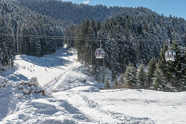 Val Di Fassa ski resort, Canazei, Italy - January, 2, 2018: Skiers skiing down the slope in Val Di Fassa ski resort in winter Dolomite Alps