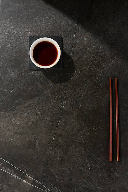 istock Soy sauce in white bowl with Japanese chopsticks, moody lighting, overhead composition 2256459732
