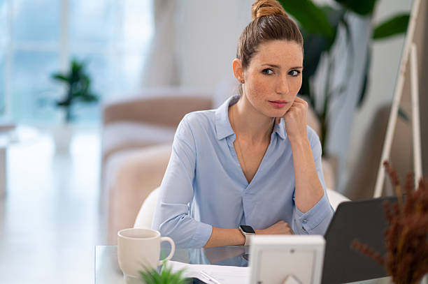 istock Young business woman looking busy while working from her home office 2256463863