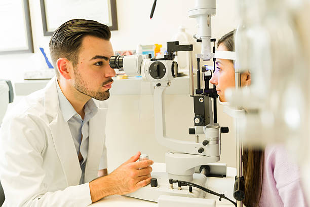 istock Hispanic ophthalmologist examining patient's vision with a slit lamp during a comprehensive eye health checkup at the clinic 2256473831