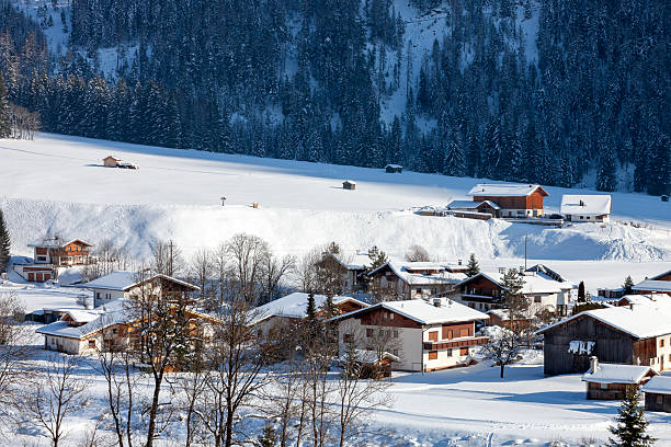 Moountain houses in a beautiful landscape in winter on a sunny day in the Austrian Alps.