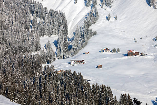 Moountain houses in a beautiful landscape in winter on a sunny day in the Austrian Alps.