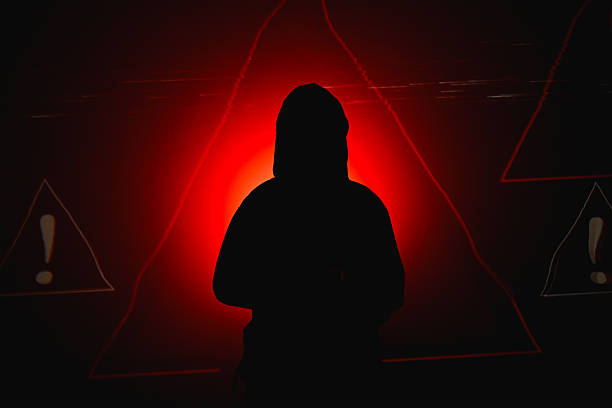 Profile of a girl in a hat on which the light shines and around her the evening sky and the park