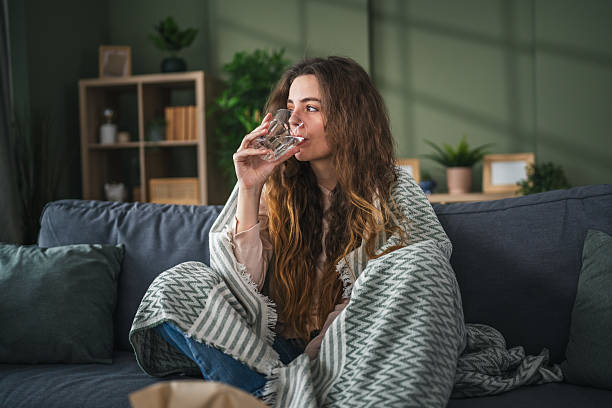 istock Young woman drinking water for hydration and wellness 2256490187