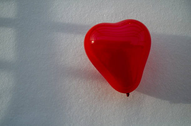 young adult female outdoors heart valentines balloons in hand