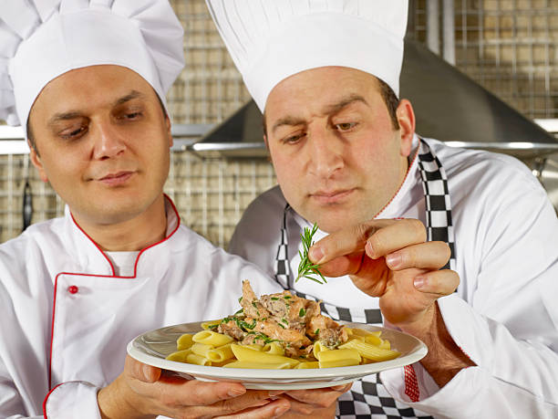 Chefs talking while cooking a commercial kitchen