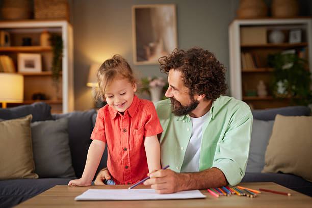 istock Father and daughter enjoying drawing activity at home 2256502220