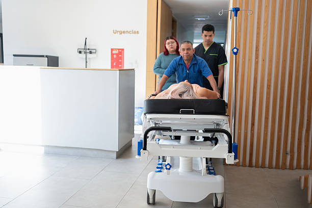 Doctors at a hospital entering the emergency ward with a patient in a gurney
