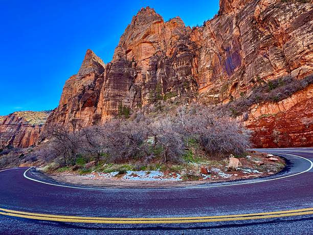 Experience the stunning landscape of Springdale, Utah, as you journey along the Watchman Trail. Towering sandstone cliffs create a dramatic backdrop against the vibrant hues of nature.