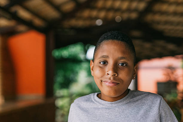Portrait of a smiling latin american boy in a park setting, enjoying the outdoors