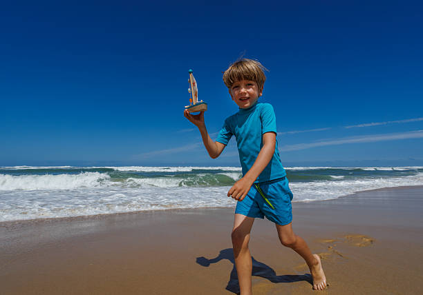 Boy playing on the seashore on the beach.